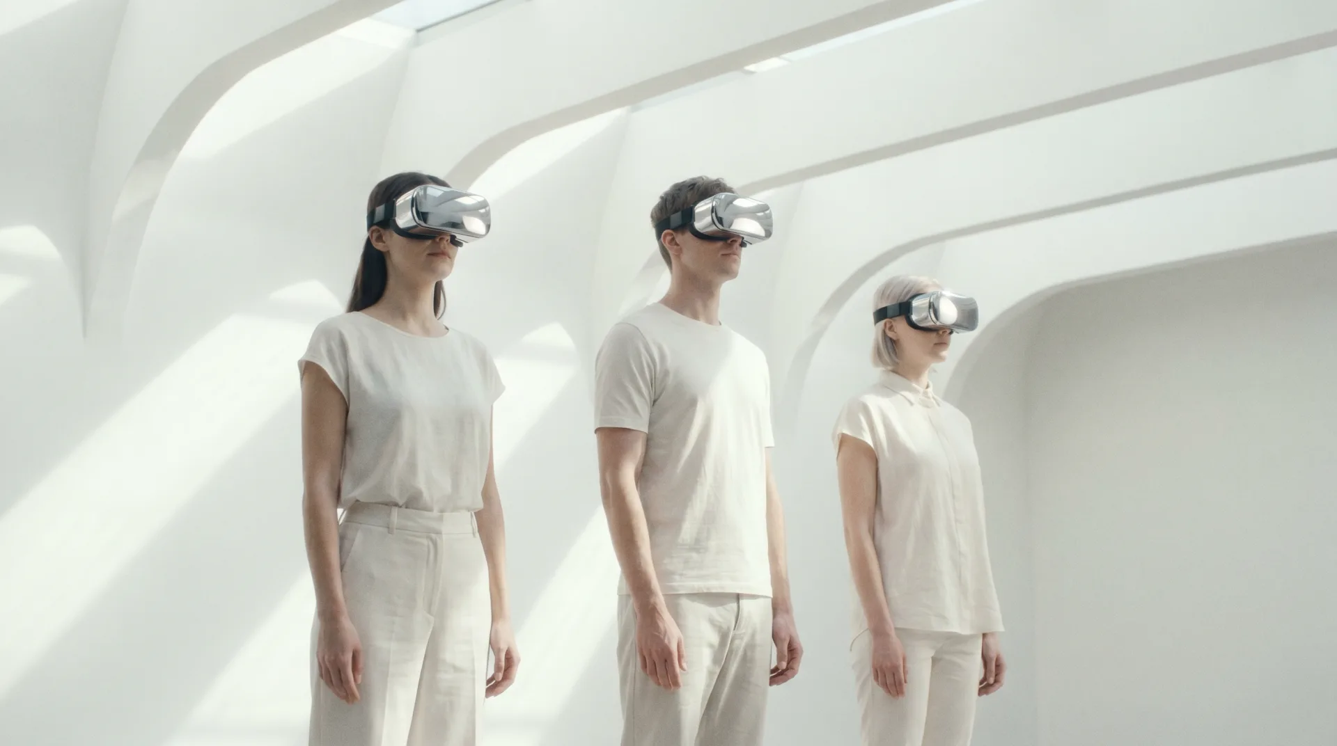Three people in VR headsets reviewing a design inside a bright architectural space